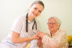 nurse holding patient's hand